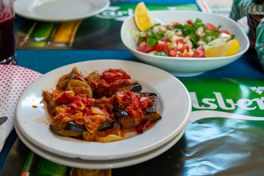 a palte of aubergines and bean salad, hearty Turkish food, in Selcuk