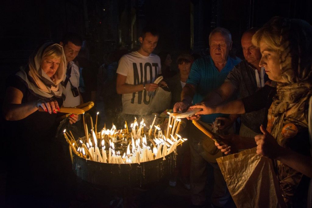 Visitors praying at the Church of the Holy Sepulchre, Jerusalem