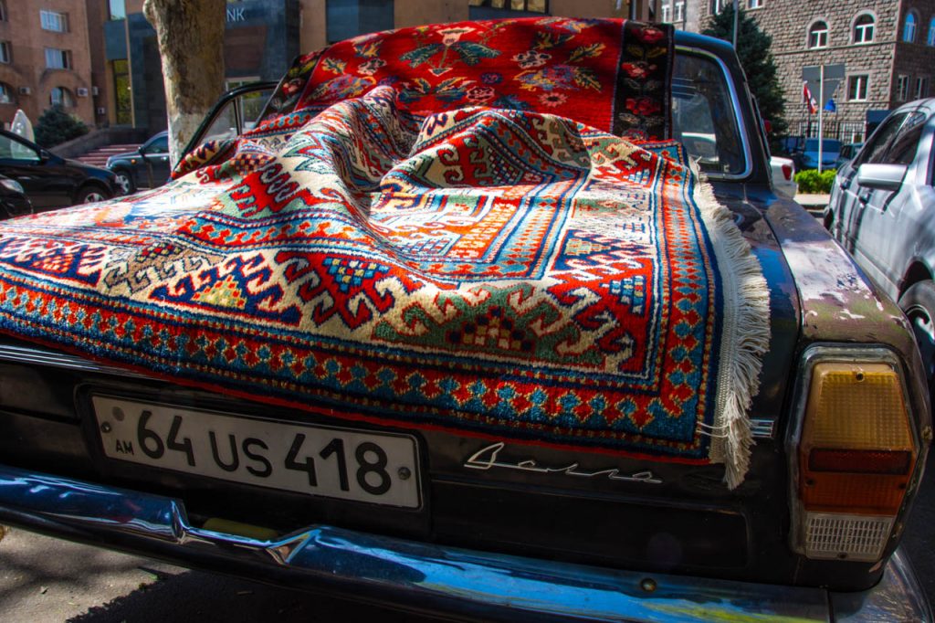 Vintage carpet displayed on a vintage Volga in Yerevan
