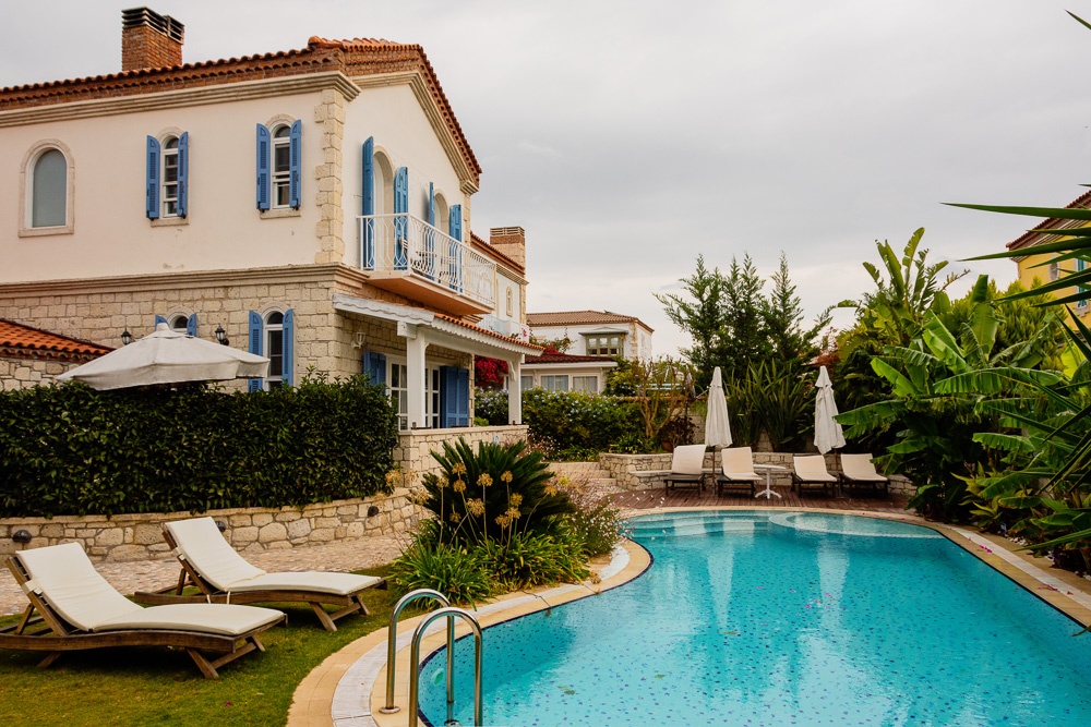 View of a small garden and pool on a grey day in Alacati
