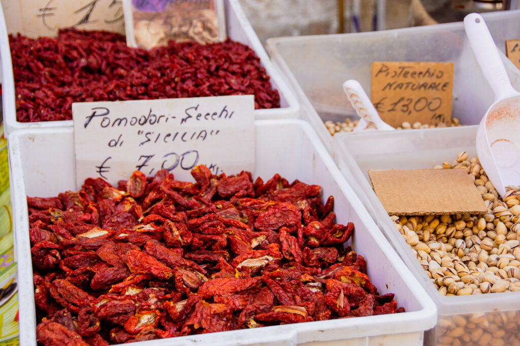 Sun dried tomatoes and pistachios for sale at the Ortigia market