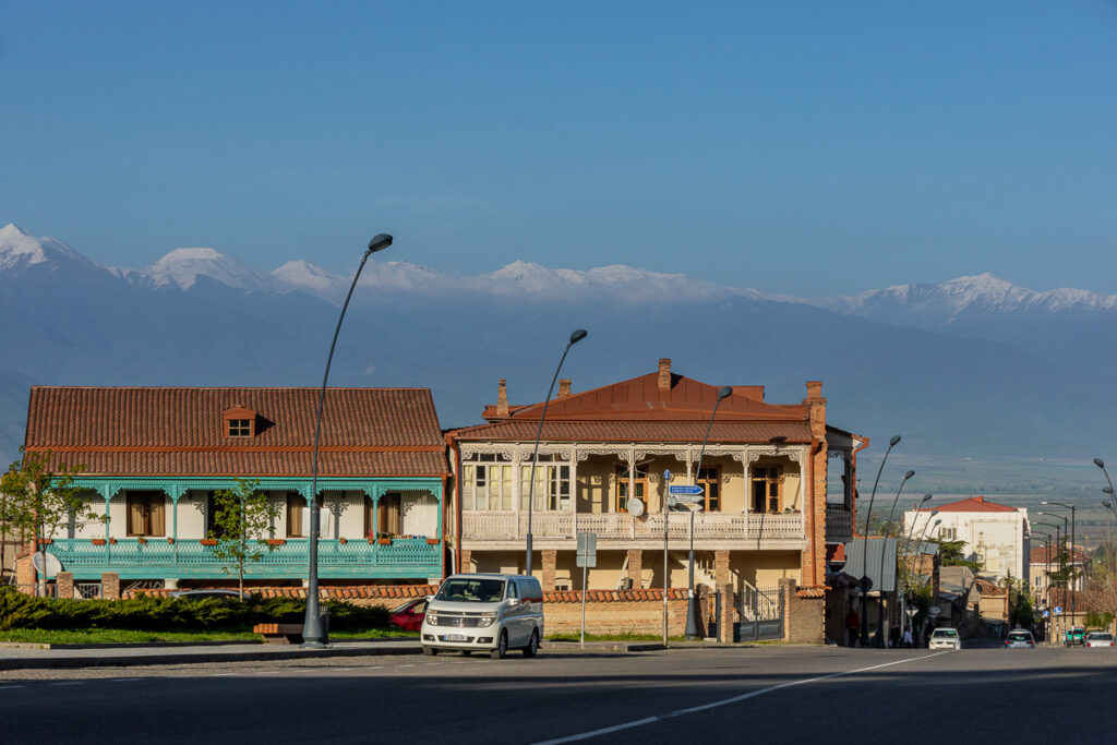 Wooden verandah houses in Telavi, KAkheti set against the Tusheti mountains