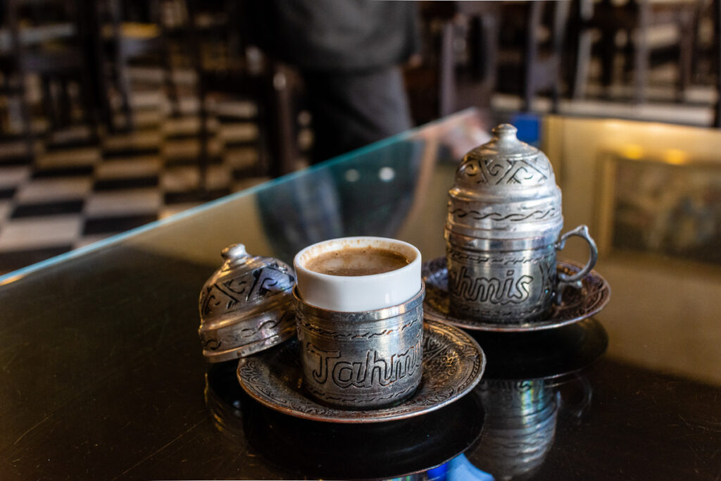 A pistachio coffee, also called menengic coffee, in its decorated tin coffee cup at the famous Tahmis coffee house, Gaziantep